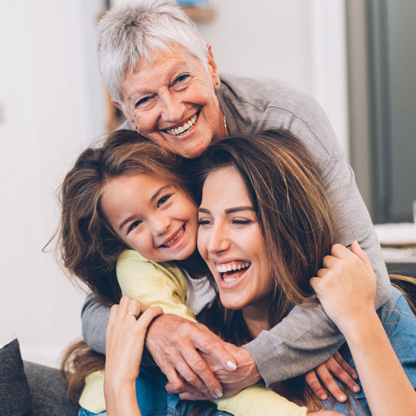 three generations of women smiling and laughing